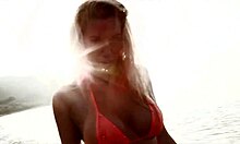 Bombshell blonde in seductive red bikini is posing for you